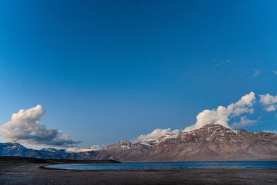 Panoramic view of sea and mountains against blue sky the andes 