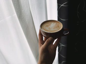 Woman holding coffee cup