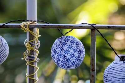 Close-up of fruits hanging on metal