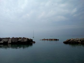 Houses by sea against sky