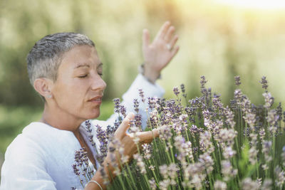 Woman smelling lavender flowers