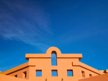 Low angle view of temple against clear blue sky