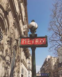 Low angle view of road sign against clear sky