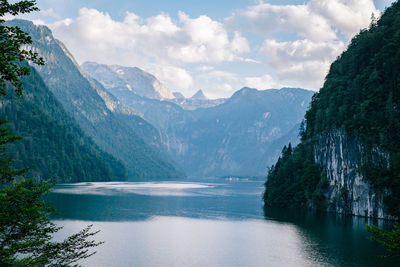 Scenic view of river and mountains against sky