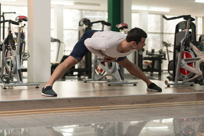 Muscular man exercising in gym