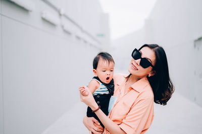 Mother and son standing on floor