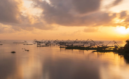 Sailboats in marina at sunset