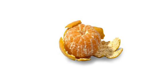 Close-up of fresh orange fruit against white background
