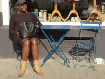 Portrait of woman sitting on chair