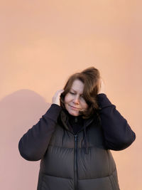 Portrait of woman standing against sky during sunset