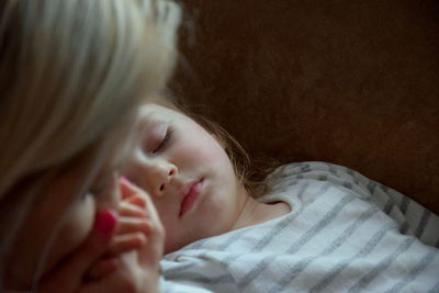 Close-up of girl sleeping on bed
