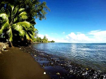 Scenic view of sea against blue sky