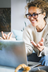 Portrait of woman using laptop at table