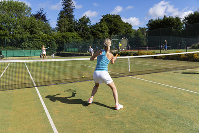 Mature women during a tennis match on grass court