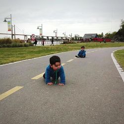 Boys playing on road