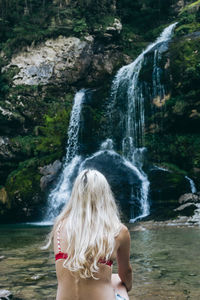 Woman in waterfall