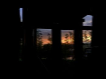 Silhouette of building seen through train window