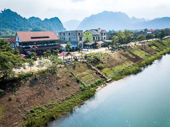 High angle view of river by buildings against sky