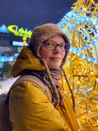 Portrait of smiling young woman standing in winter