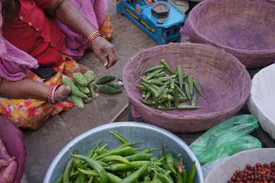 Low section of woman selling vegetables at market