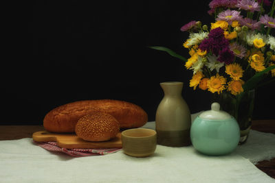 Close-up of vase on table against black background