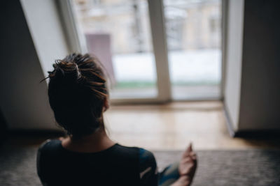 Rear view of woman at home