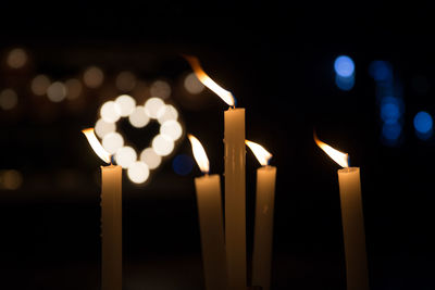 Close-up of lit candle in dark room