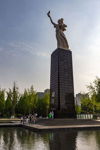 Low angle view of statue against sky