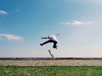 Full length of young woman jumping in mid-air