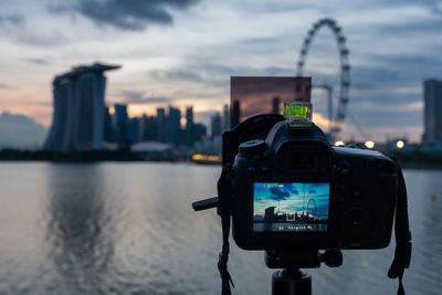 Close-up of camera against sky in city