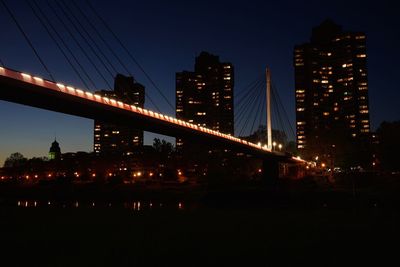 Illuminated bridge at night