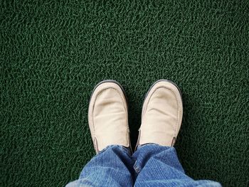 Low section of man standing on doormat