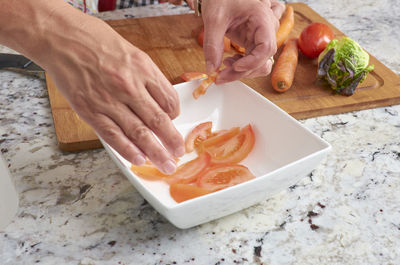 High angle view of man preparing food on cutting board