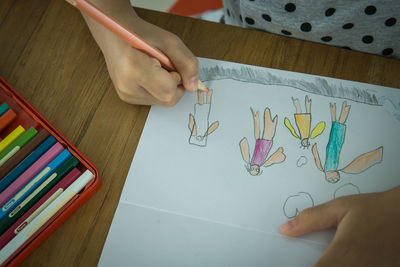 High angle view of human hand holding paper