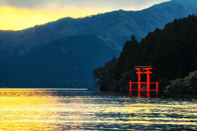 Scenic view of lake and mountains against sky