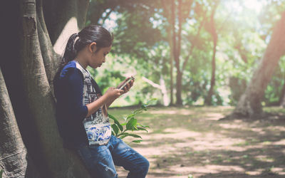 Side view of man using mobile phone