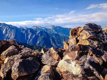 Scenic view of rocky mountains against cloudy sky