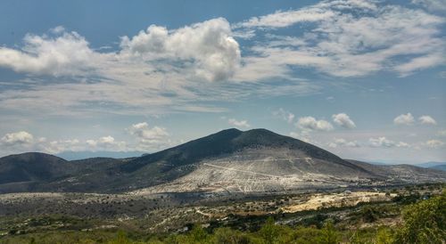 Scenic view of mountains against cloudy sky