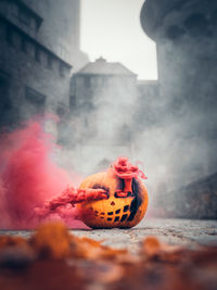 Close-up of pumpkin against buildings in city