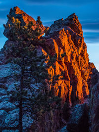 Low angle view of rocky mountain against sky