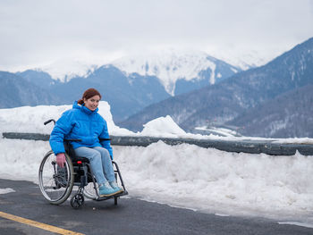 Rear view of man skiing on snowcapped mountains