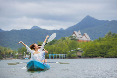 Woman in boat on mountain against sky