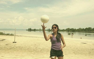 Full length of woman standing on beach