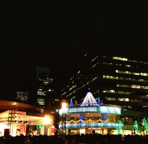 Low angle view of illuminated building against sky at night