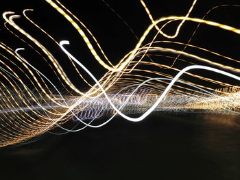 Light trails against sky at night