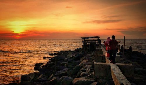 Scenic view of sea against orange sky