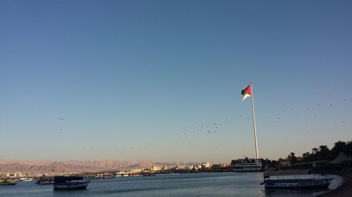 Scenic view of flag against clear sky