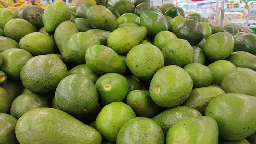 Full frame shot of green avocados fruits for sale in market