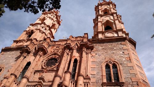 Low angle view of bell tower against sky