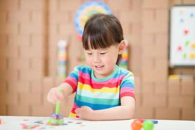 Young girl play magical magnet experiments at home for homeschooling